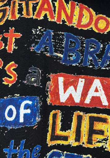 Close-up of colorful vintage letter graphic print on men t-shirt, custom printing service, oem clothing